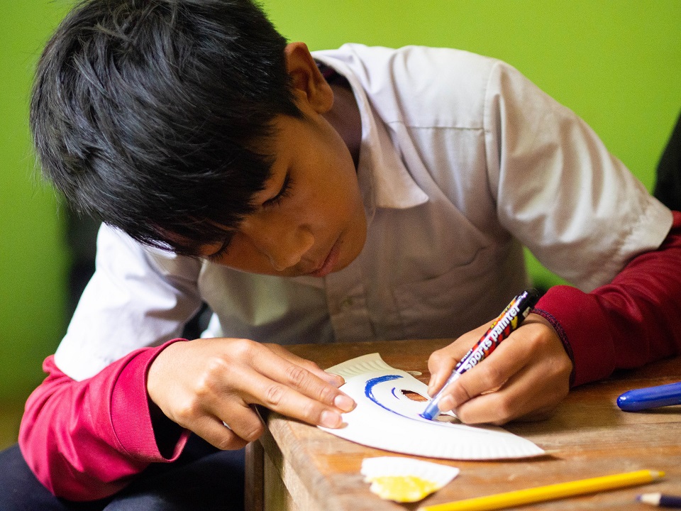 Kamsia, one of the volunteers’ sweethearts, making his own paper mask.