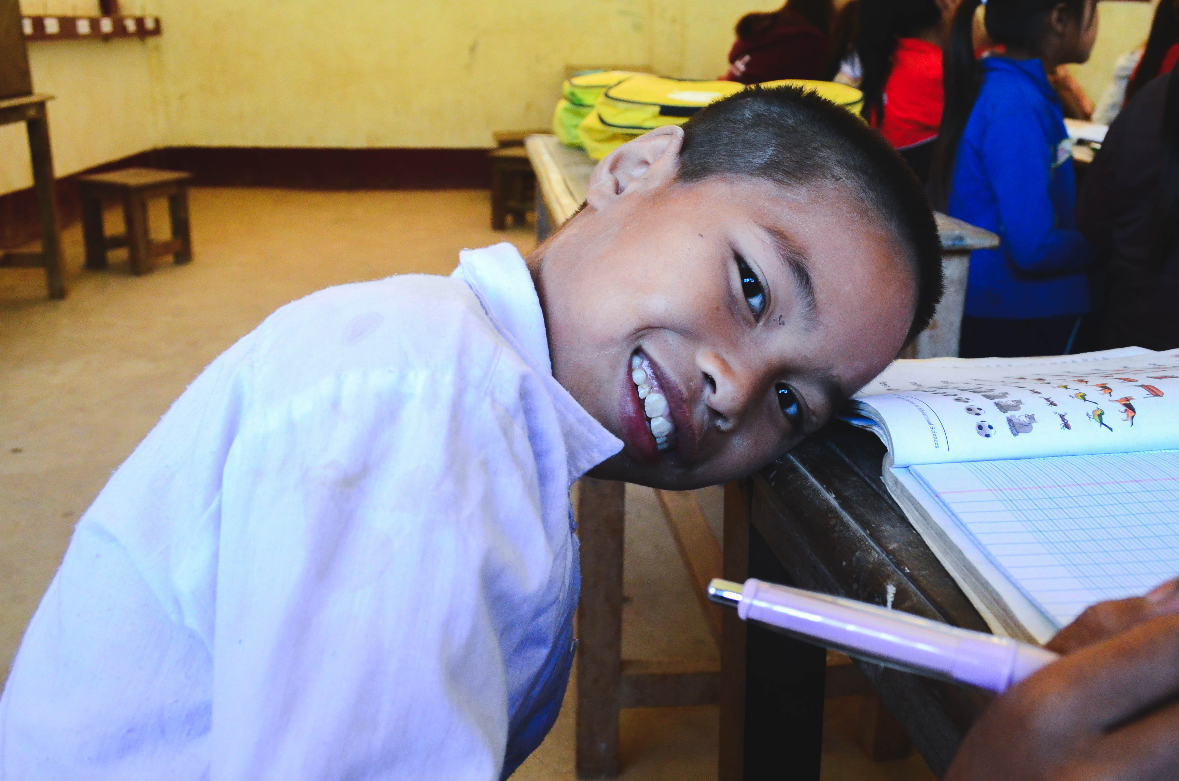 Boon Lup takes a break from writing by giving the camera a gorgeous smile.