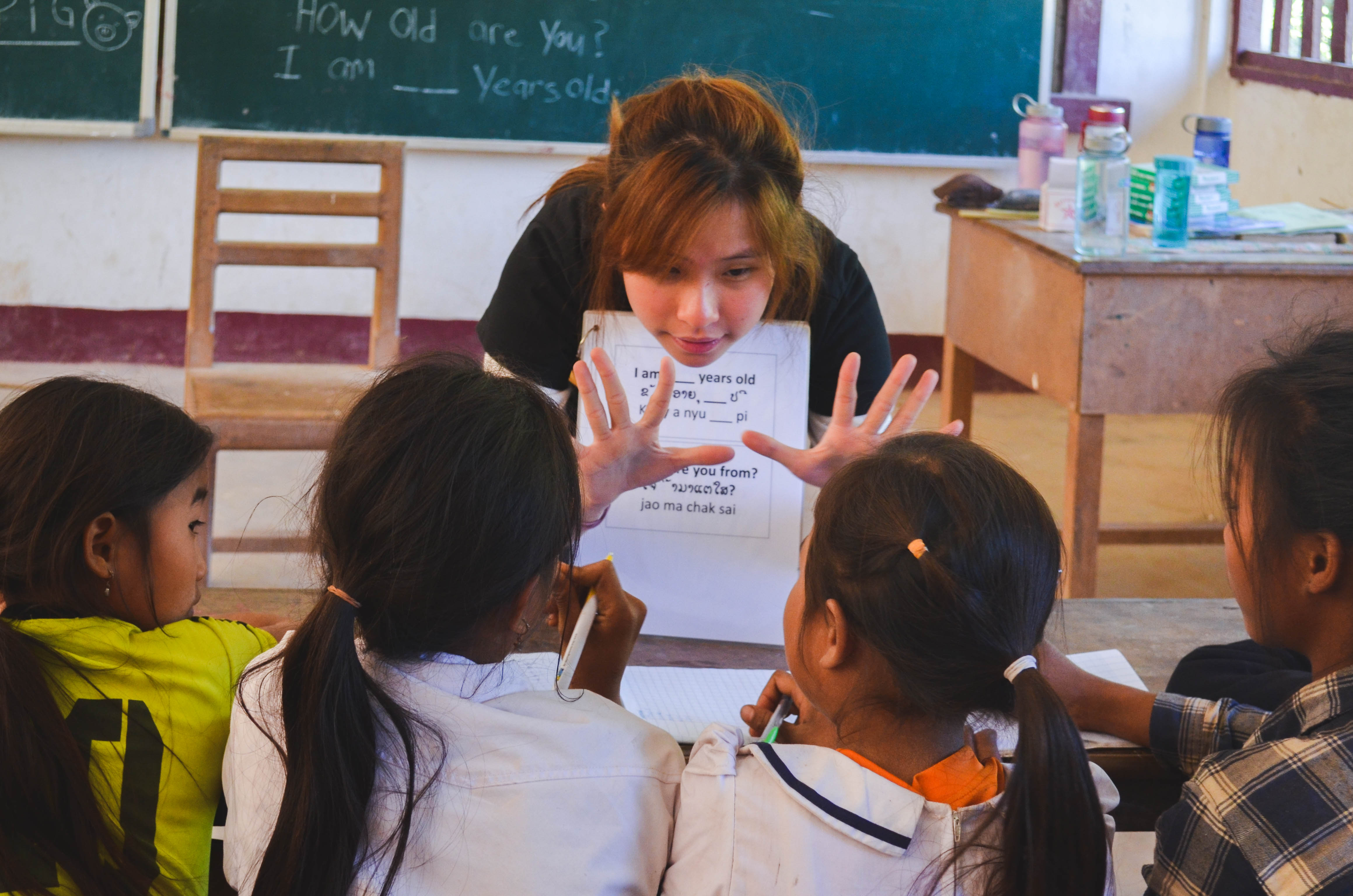 Our volunteer, Nicolette, being super hands-on while teaching the children basic conversational English.